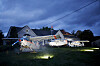 Full-size airplanes in a lit Halloween display outside a home in Dalton beneath dark, cloudy skies.