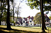 Historic Elm Court estate building behind a lawn and trees in Lenox, Massachusetts.